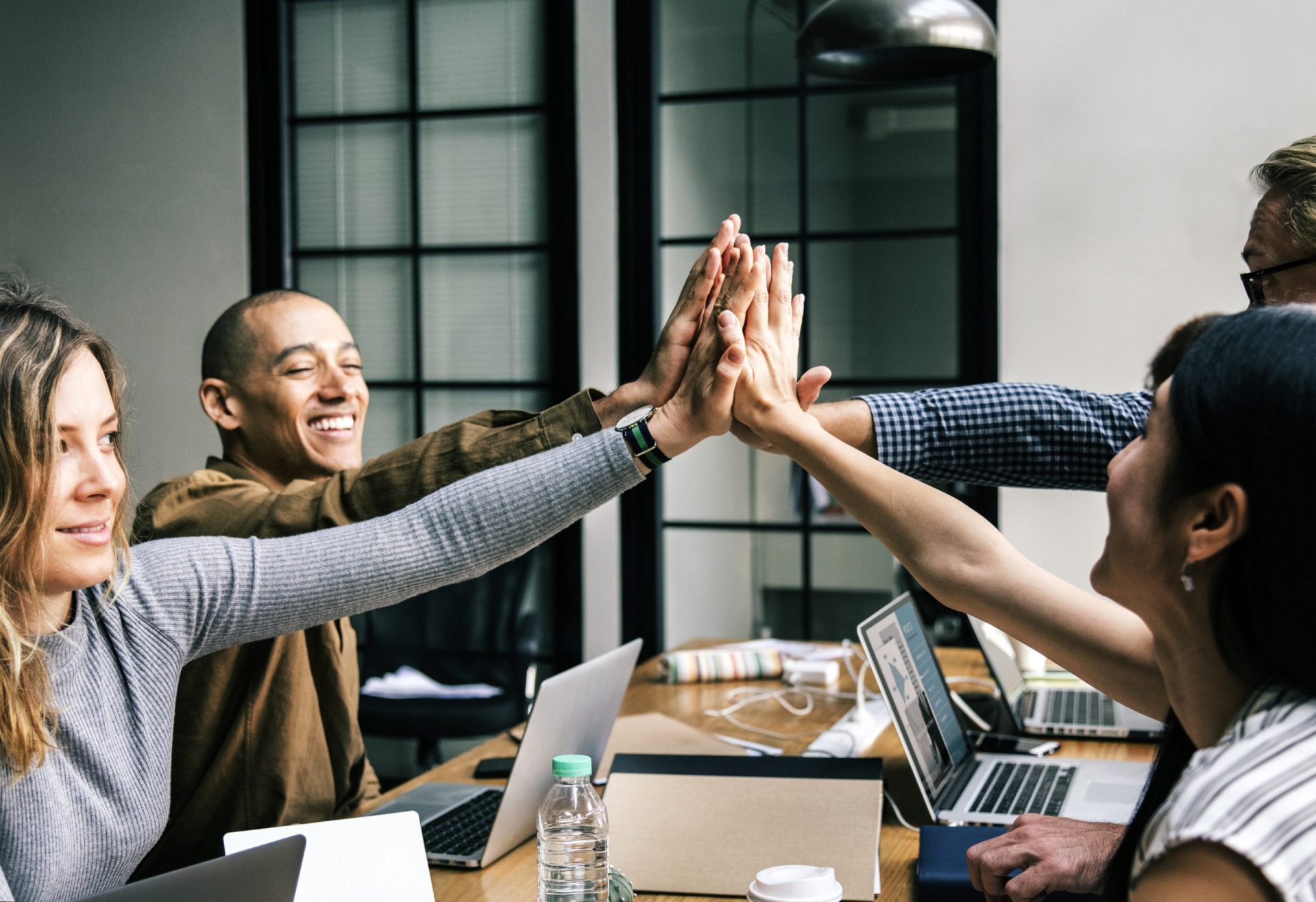 RemarkablePeople team hands together